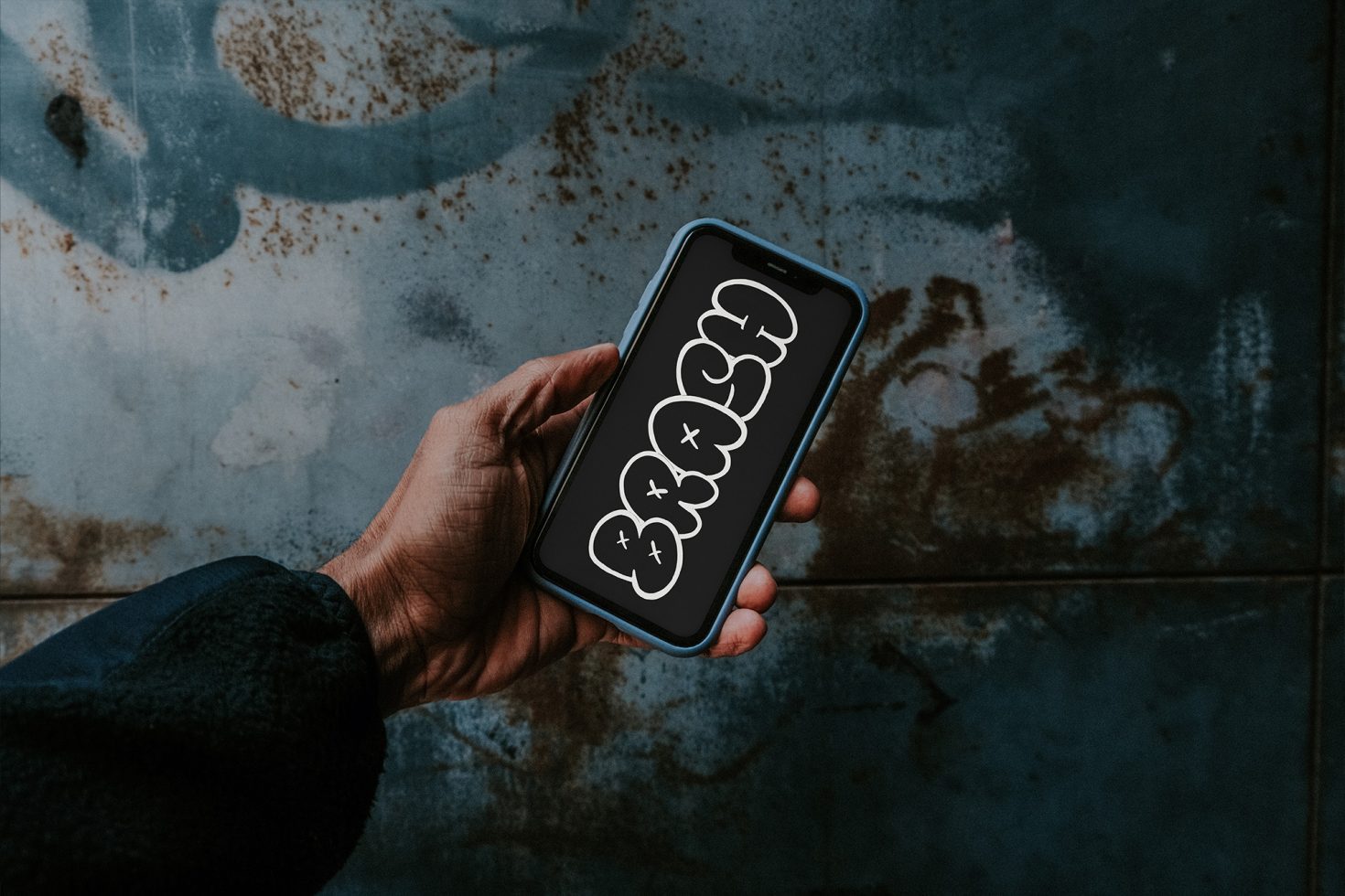 Person holding smartphone with speech bubble graphics, showcasing mobile UI design mockup on a textured background.